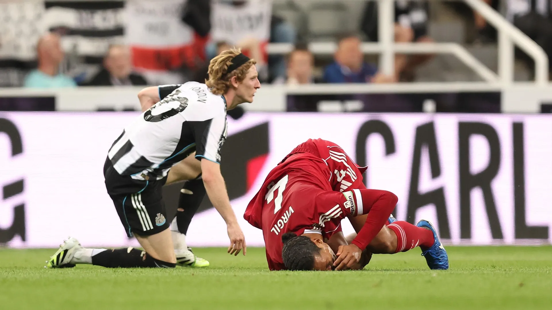 Newcastle United v Liverpool - Premier League's Virgil van Dijk injured on the ground in St James’ Park after Anthony Gordon red card